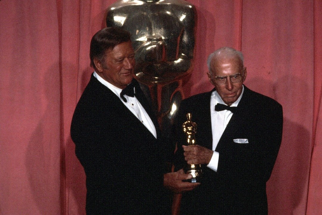 American actor John Wayne and Director Howard Hawks, Academy Honorary Award winner pose backstage during the 47th Academy Awards at Dorothy Chandler Pavilion in Los Angeles, California. | Source: Getty Images