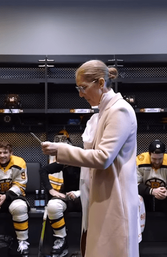 Celine Dion reading the lineup in the Bruins' locker room | Source: Instagram.com/nhlbruins